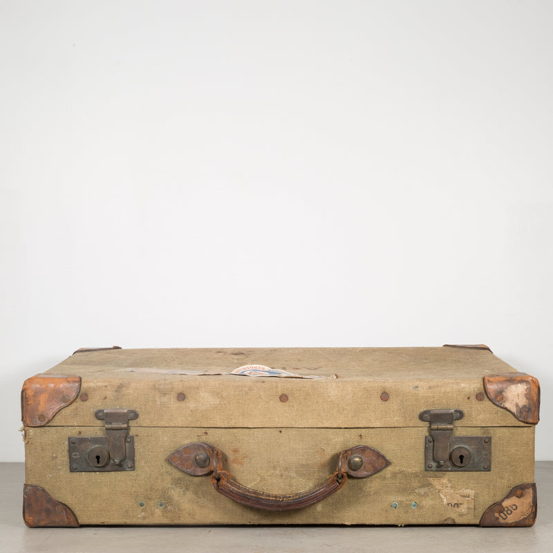 A GROUP OF SEVEN CANVAS AND LEATHER SUITCASES